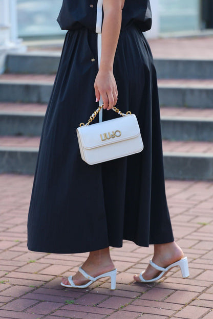 Conjunto Preto Elegante – Top + Saia Midi com Bolsos